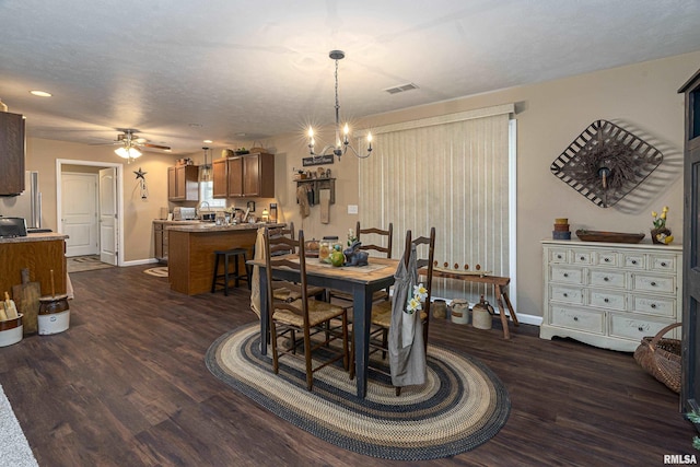 dining room featuring visible vents, baseboards, dark wood finished floors, and ceiling fan with notable chandelier