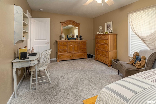 bedroom featuring light carpet, a ceiling fan, and baseboards