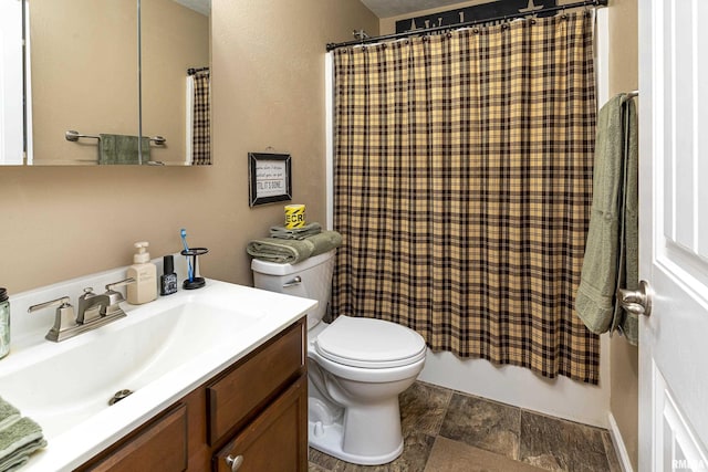 full bath with shower / bath combination with curtain, stone finish flooring, toilet, and vanity