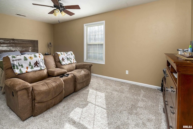 living area featuring carpet flooring, baseboards, visible vents, and ceiling fan