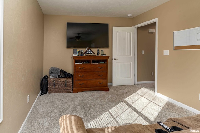 carpeted living room with baseboards