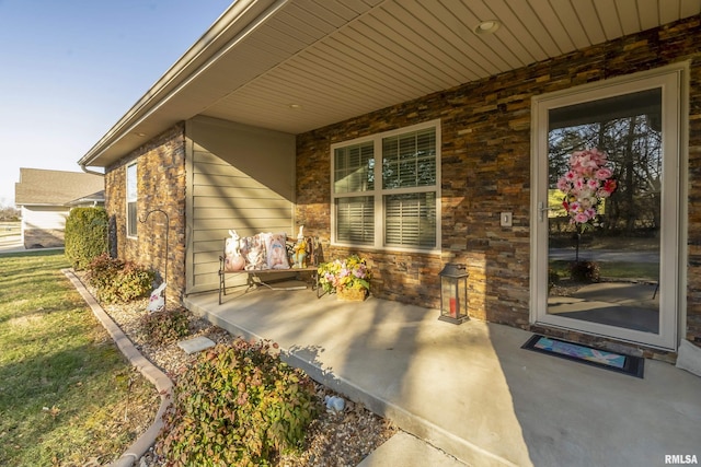 property entrance featuring stone siding, brick siding, and a porch