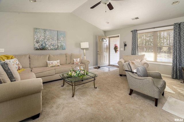 living area with light carpet, visible vents, baseboards, and vaulted ceiling