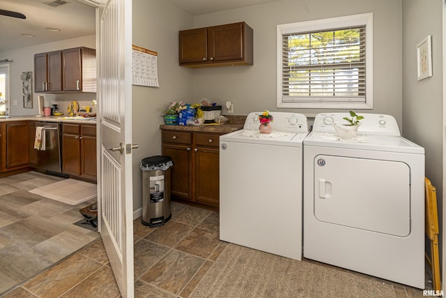 laundry area featuring cabinet space, washing machine and dryer, and visible vents