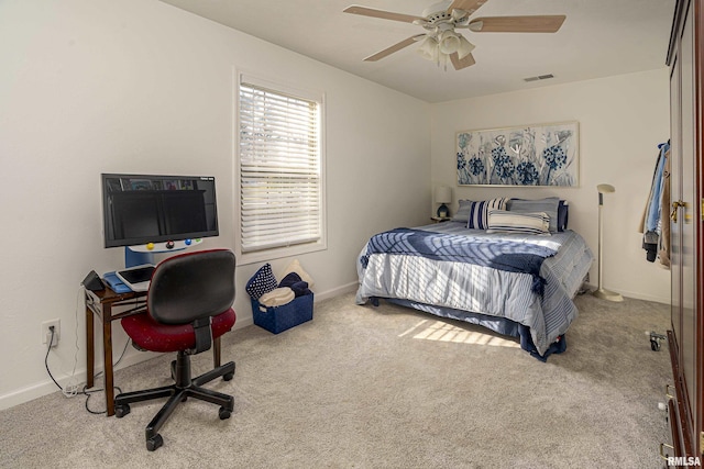 bedroom featuring visible vents, baseboards, carpet, and a ceiling fan