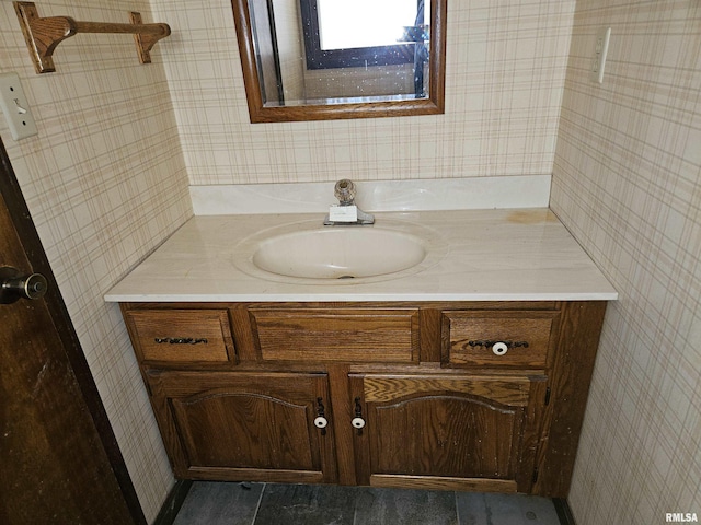 bathroom with vanity and wallpapered walls