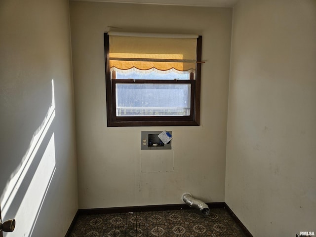 clothes washing area featuring laundry area, hookup for a washing machine, and baseboards