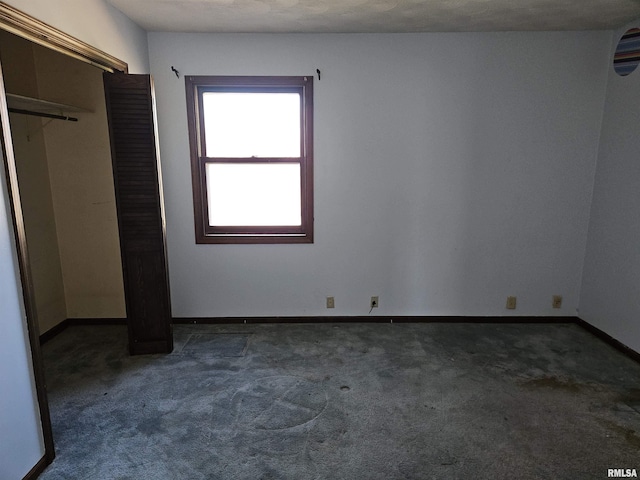 unfurnished bedroom featuring carpet flooring and baseboards