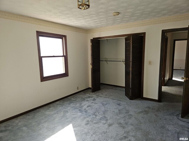 unfurnished bedroom with carpet flooring, baseboards, and a closet