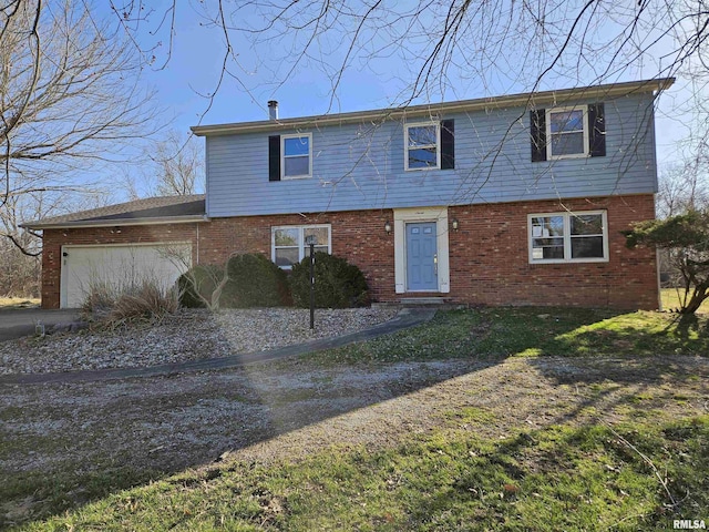 colonial home with brick siding and an attached garage