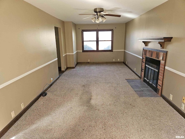 unfurnished living room featuring a brick fireplace, a ceiling fan, baseboards, and carpet floors