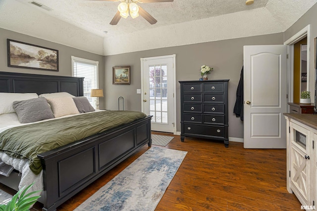 bedroom featuring access to exterior, visible vents, baseboards, dark wood finished floors, and vaulted ceiling