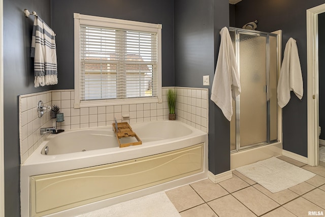 full bath featuring tile patterned floors, a garden tub, and a shower stall