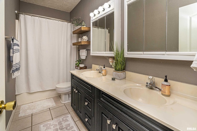 full bath featuring tile patterned floors, toilet, a textured ceiling, and a sink