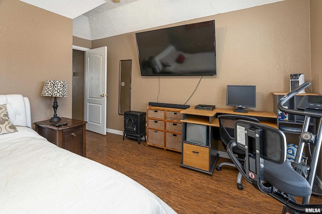 bedroom with vaulted ceiling, dark wood-style floors, and baseboards