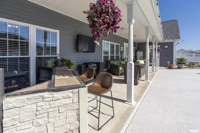 view of patio featuring an outdoor living space and fence