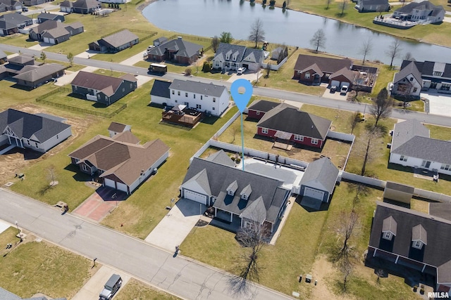 drone / aerial view with a residential view and a water view