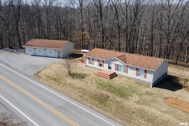 birds eye view of property featuring a wooded view