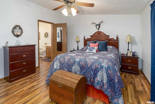 bedroom featuring a textured ceiling, ensuite bath, wood finished floors, and a ceiling fan