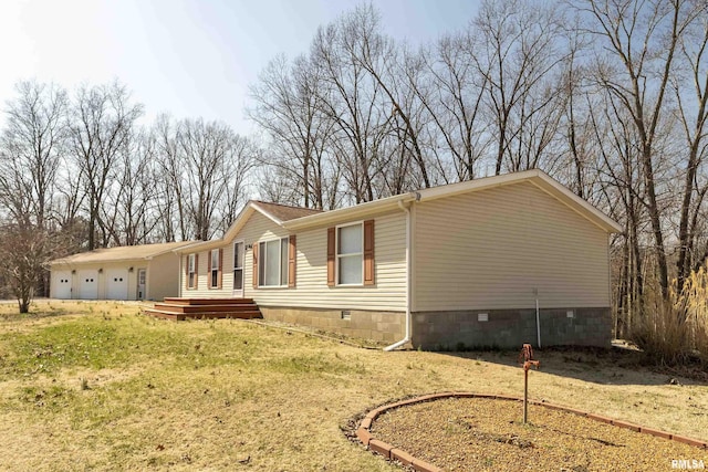 view of property exterior featuring crawl space and a garage