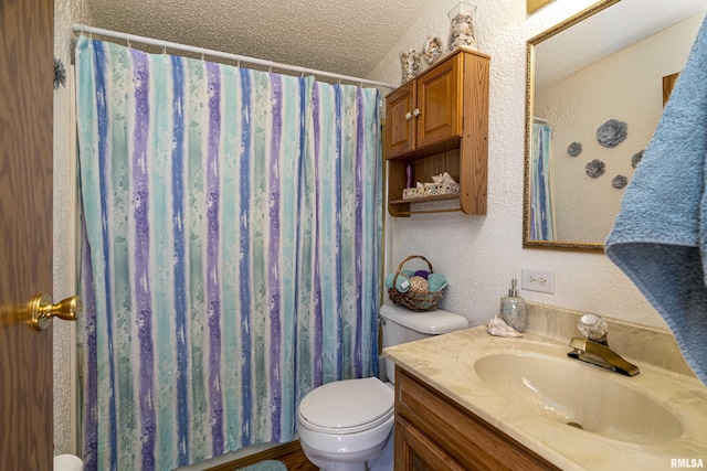 bathroom with vanity, a shower with curtain, a textured ceiling, toilet, and a textured wall