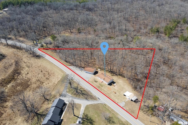 birds eye view of property with a view of trees