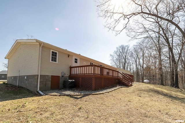 rear view of house with a wooden deck