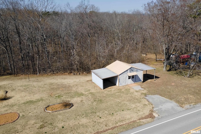 drone / aerial view featuring a view of trees