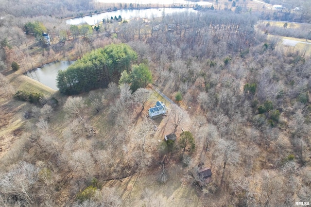 bird's eye view featuring a wooded view and a water view