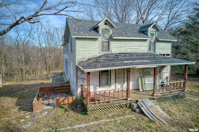 view of front of property featuring roof with shingles and covered porch