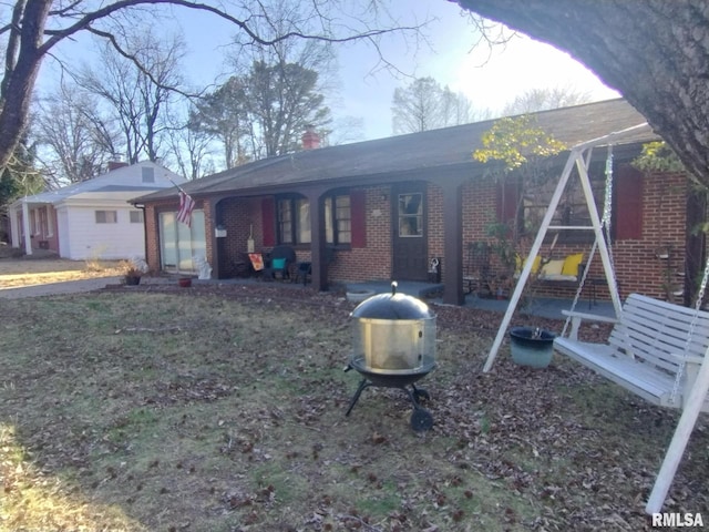 ranch-style house with brick siding and a chimney