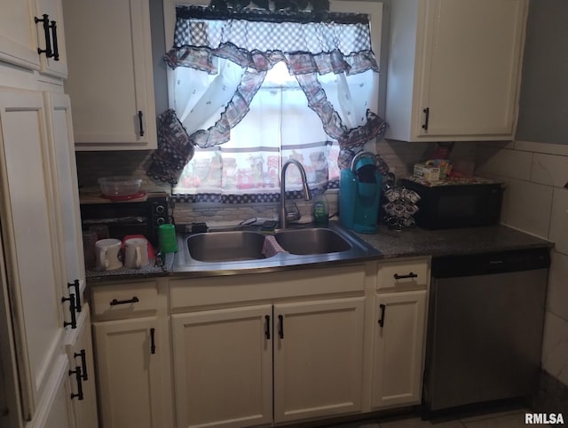 kitchen with stainless steel dishwasher, decorative backsplash, white cabinets, and a sink