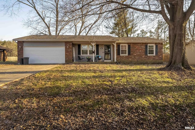 single story home with brick siding, a front lawn, concrete driveway, and a garage