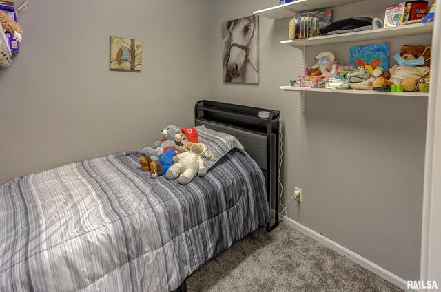 carpeted bedroom featuring baseboards