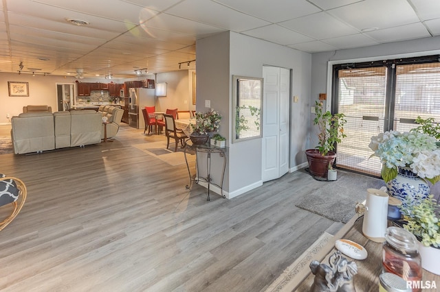 entrance foyer with a wealth of natural light, a drop ceiling, light wood finished floors, and visible vents