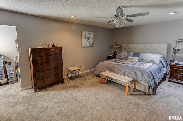 carpeted bedroom featuring baseboards, a textured ceiling, and a ceiling fan