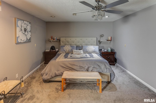 carpeted bedroom featuring baseboards, a textured ceiling, and a ceiling fan