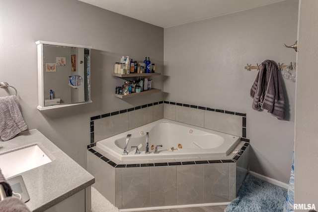 bathroom with a jetted tub and vanity