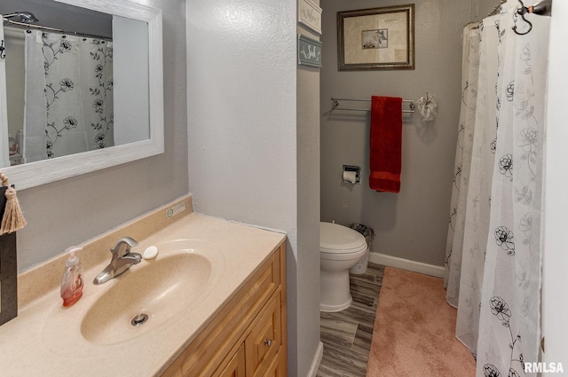 full bath featuring curtained shower, baseboards, toilet, wood finished floors, and vanity