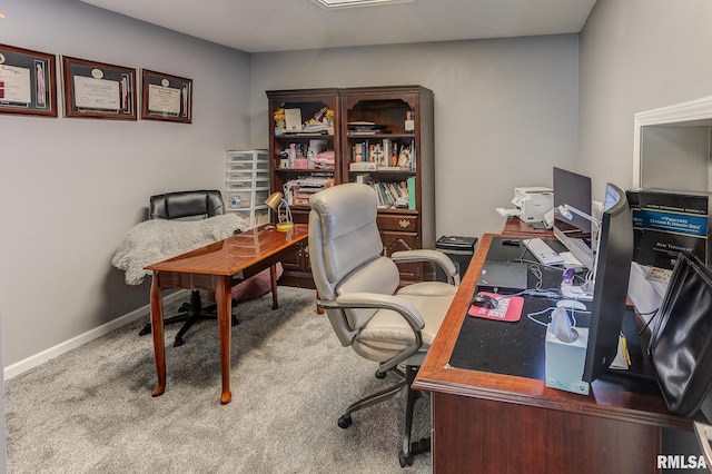 carpeted home office featuring baseboards