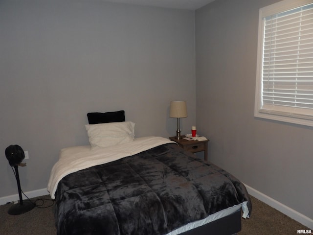 bedroom with baseboards and carpet floors