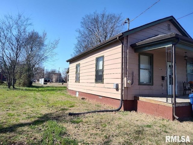 407 N Ohio St, Mound City, IL 62963 - view of property exterior featuring crawl space, a yard, and a porch