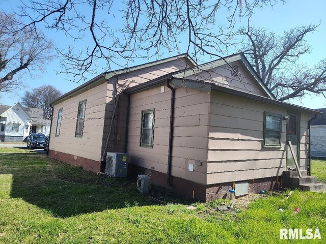 407 N Ohio St, Mound City, IL 62963 - view of home's exterior featuring central air condition unit, entry steps, ac unit, a yard, and crawl space