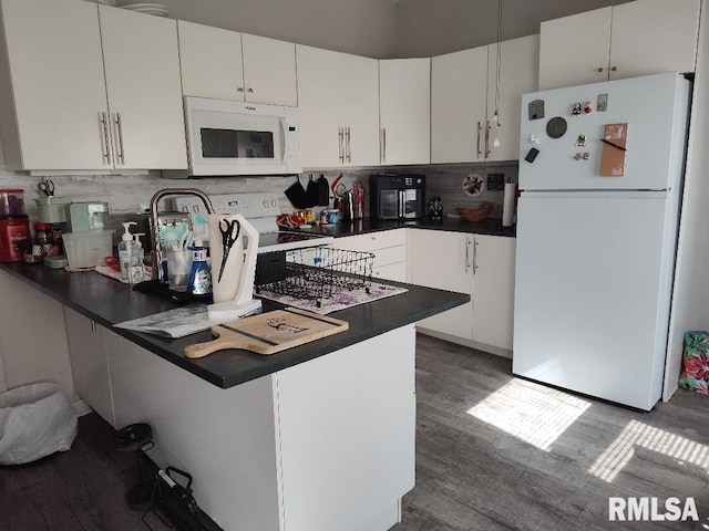 407 N Ohio St, Mound City, IL 62963 - kitchen with dark countertops, white appliances, tasteful backsplash, and a peninsula