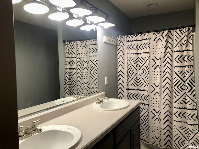 full bathroom with double vanity, a shower with shower curtain, and a sink