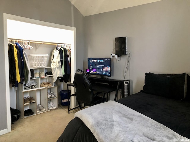 carpeted bedroom with a closet and lofted ceiling