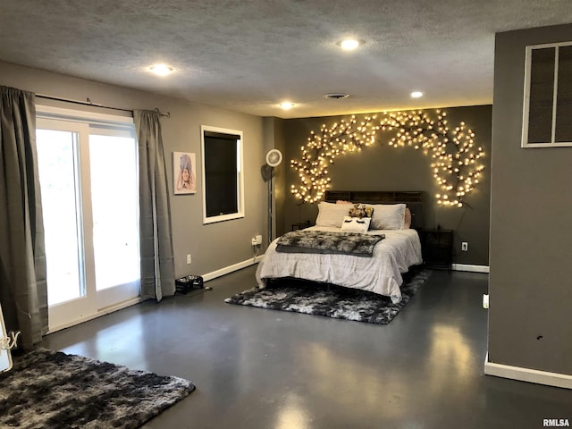 bedroom featuring visible vents, baseboards, a textured ceiling, and concrete flooring