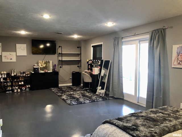 interior space with a textured ceiling and finished concrete flooring