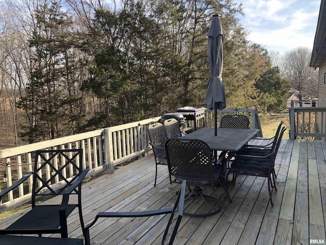 wooden terrace with outdoor dining area