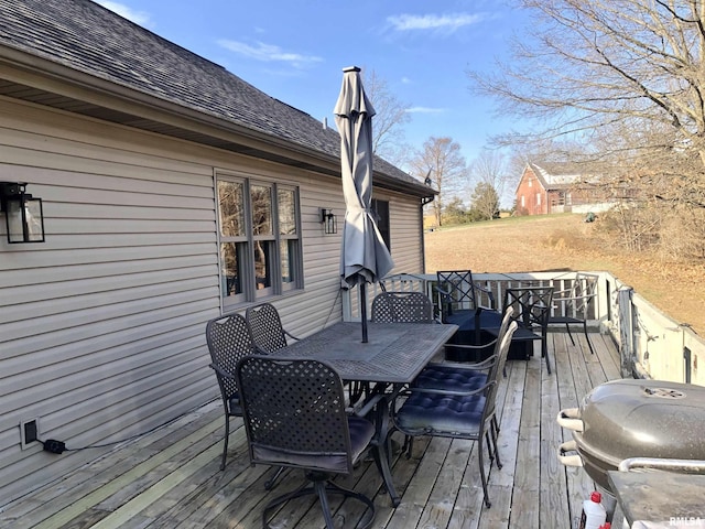 deck with grilling area and outdoor dining space